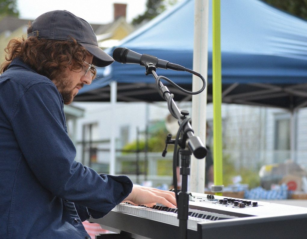 Jonas Myers playing piano at the farmers market